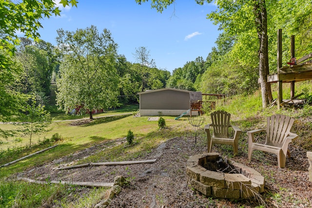 view of yard featuring an outdoor fire pit