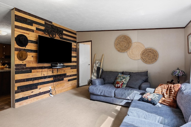 living room featuring ornamental molding, wood walls, a textured ceiling, and carpet floors