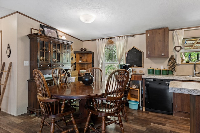 dining room featuring a textured ceiling, ornamental molding, and dark hardwood / wood-style floors