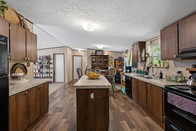 kitchen featuring black appliances, dark hardwood / wood-style floors, sink, and a center island