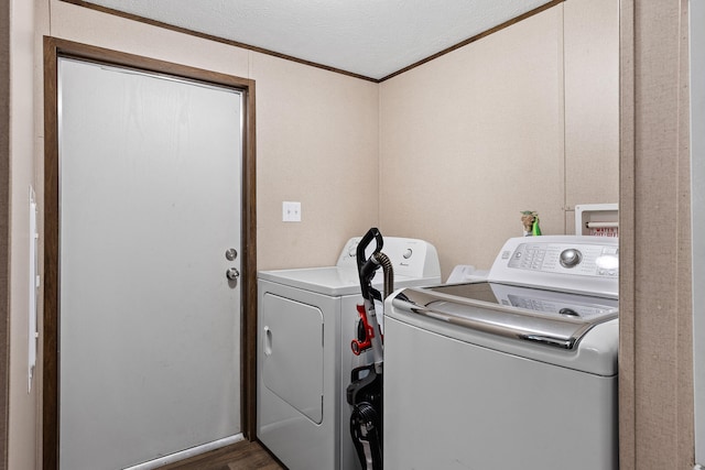 washroom featuring a textured ceiling, crown molding, dark hardwood / wood-style floors, and independent washer and dryer