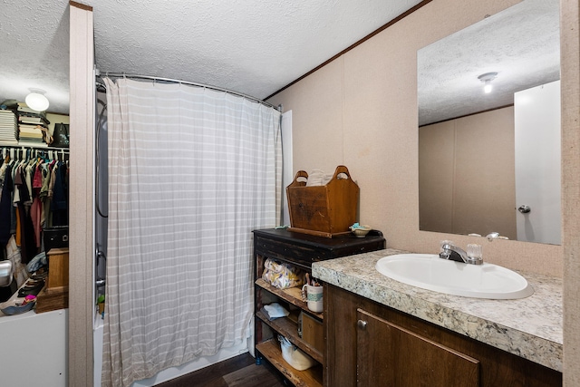 bathroom featuring vanity, shower / bath combo with shower curtain, a textured ceiling, and hardwood / wood-style flooring