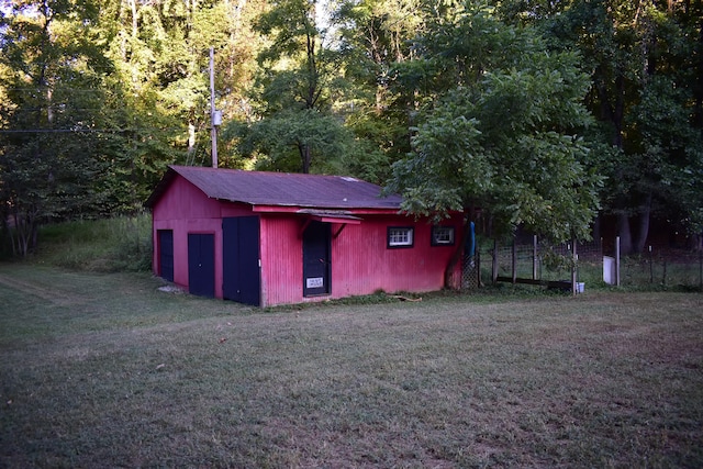 view of outbuilding featuring a yard