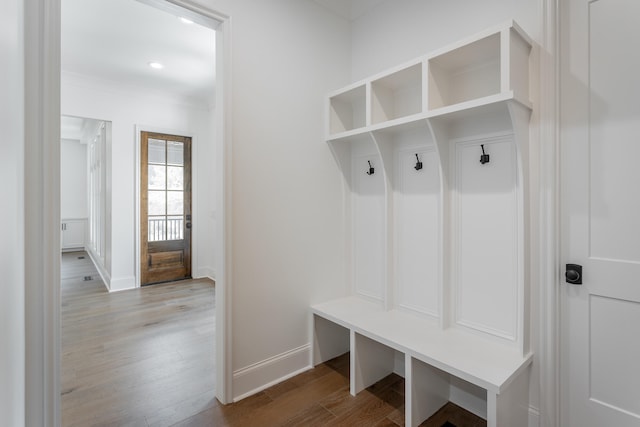 mudroom with light hardwood / wood-style flooring and ornamental molding