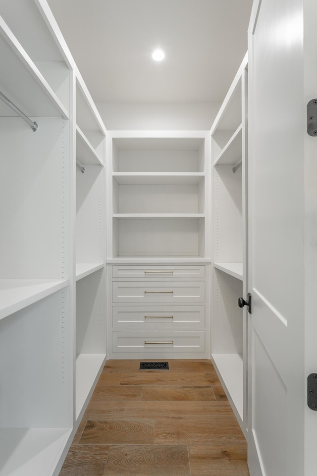 spacious closet featuring light wood-type flooring