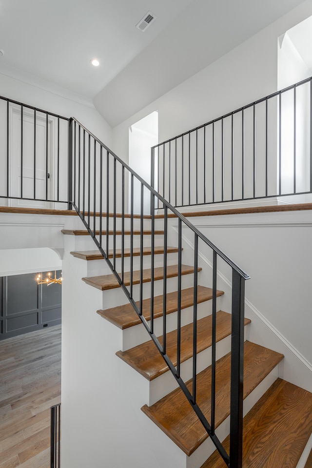 stairs with hardwood / wood-style floors