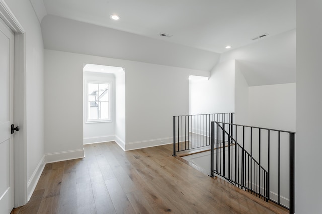 interior space with light hardwood / wood-style floors and vaulted ceiling