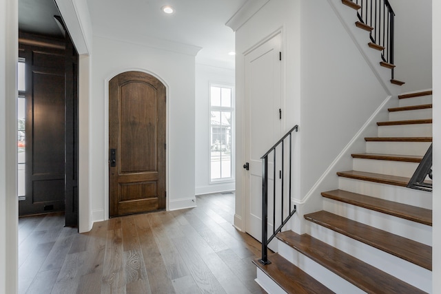 foyer entrance featuring hardwood / wood-style flooring and ornamental molding