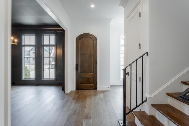 entrance foyer featuring hardwood / wood-style flooring and ornamental molding