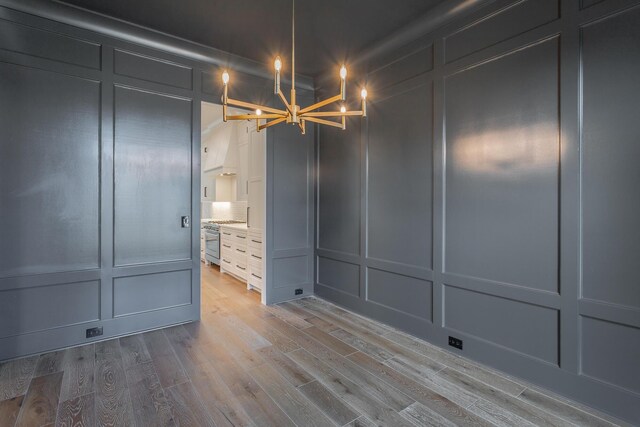 interior space with light hardwood / wood-style flooring and an inviting chandelier