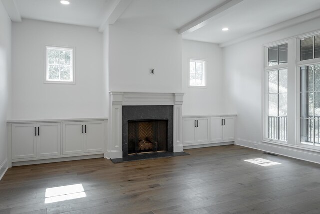 unfurnished living room featuring wood-type flooring and a high end fireplace