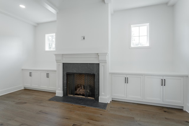 unfurnished living room with a high end fireplace and hardwood / wood-style flooring