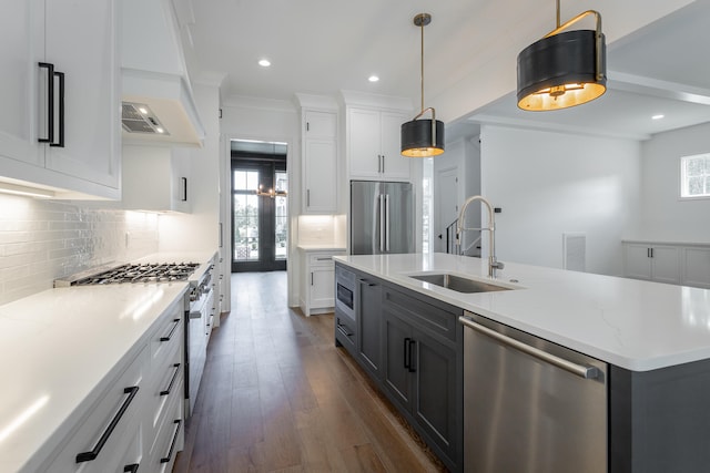 kitchen featuring white cabinets, sink, backsplash, dark wood-type flooring, and appliances with stainless steel finishes