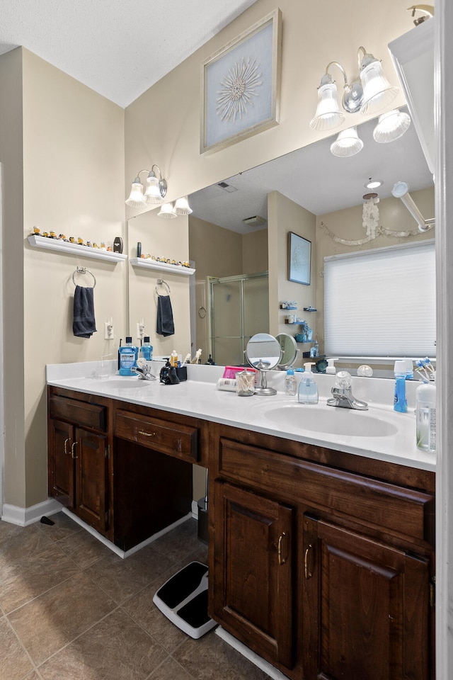 bathroom with tile patterned flooring, vanity, and a shower with shower door