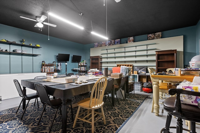 dining space with ceiling fan, concrete floors, and a textured ceiling