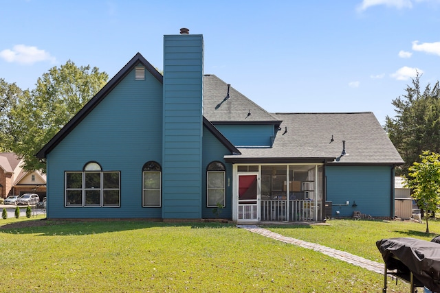 back of property with a lawn and a sunroom