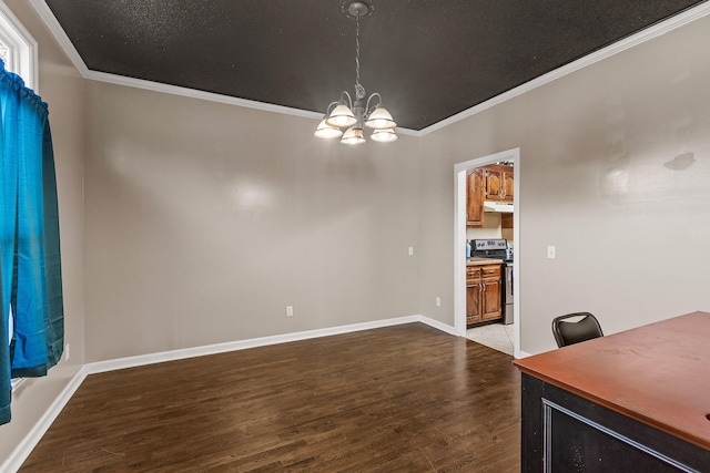 unfurnished dining area with hardwood / wood-style floors, crown molding, and a notable chandelier