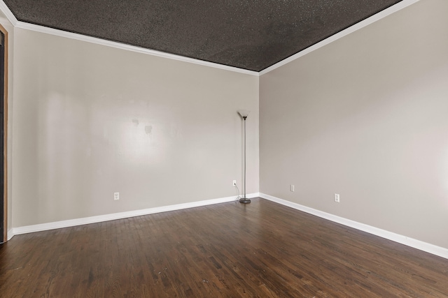 empty room with a textured ceiling, dark hardwood / wood-style floors, and crown molding