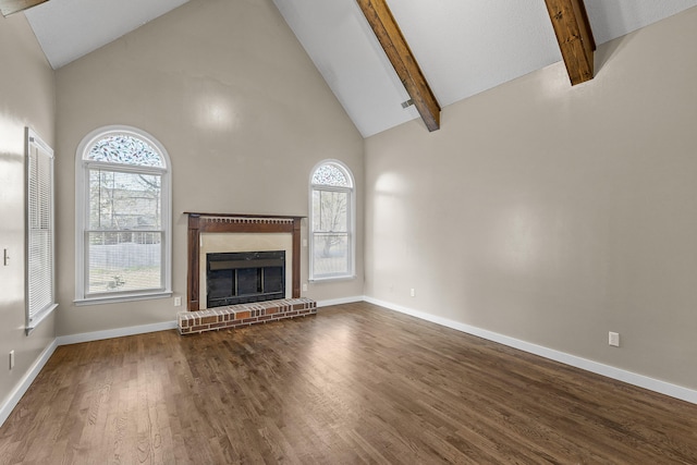 unfurnished living room with beam ceiling, hardwood / wood-style floors, high vaulted ceiling, and a brick fireplace