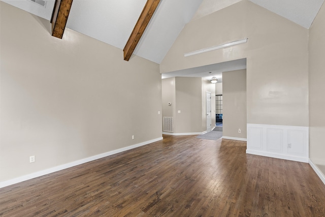 unfurnished living room featuring beam ceiling, high vaulted ceiling, and dark wood-type flooring