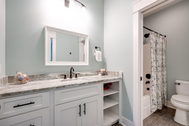 full bathroom featuring shower / tub combo, hardwood / wood-style floors, vanity, and toilet