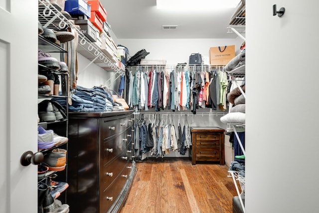 spacious closet with hardwood / wood-style flooring