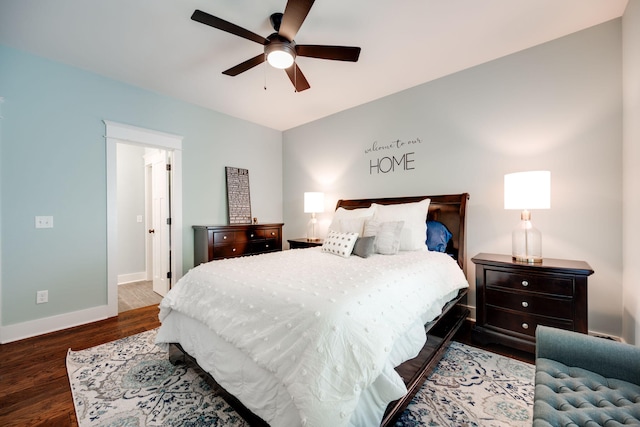 bedroom with dark hardwood / wood-style flooring and ceiling fan