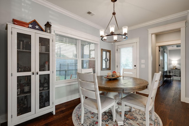 dining room with crown molding, dark hardwood / wood-style flooring, and a notable chandelier