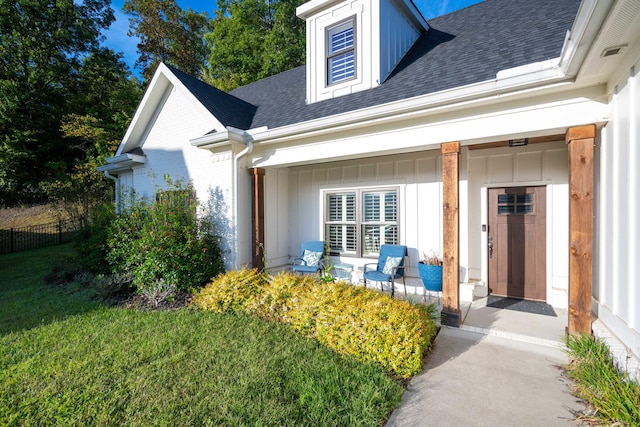 entrance to property featuring a yard