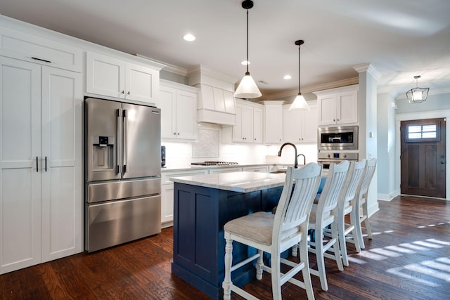 kitchen with pendant lighting, appliances with stainless steel finishes, dark hardwood / wood-style floors, and white cabinetry