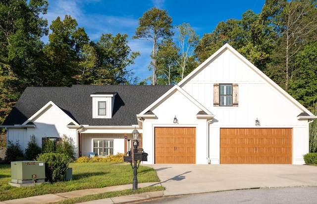 modern farmhouse style home with a garage and a front lawn