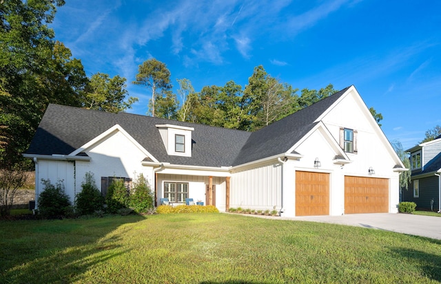 modern farmhouse style home featuring a front yard and a garage