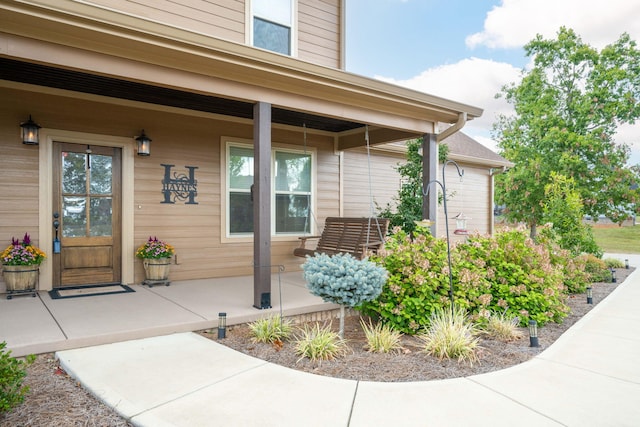 doorway to property with a porch