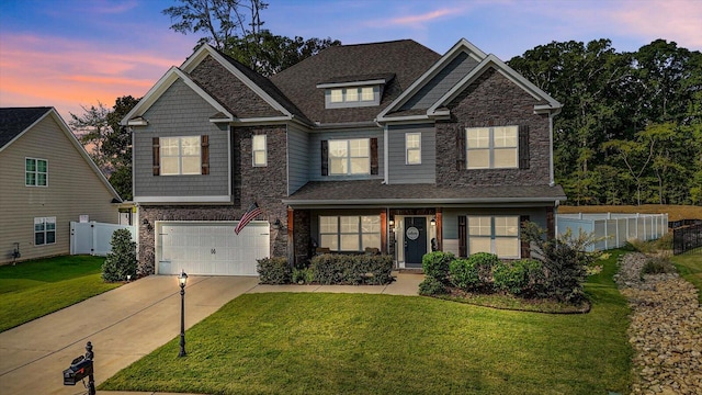 craftsman-style home with a garage and a yard