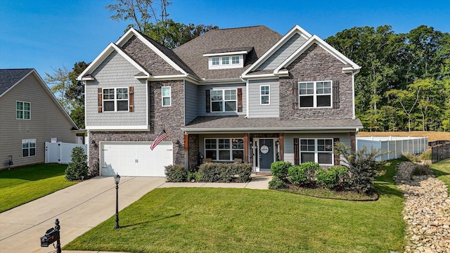 craftsman house featuring a front yard and a garage