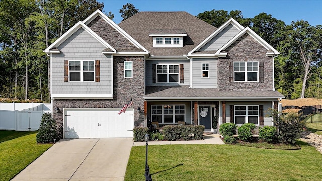 craftsman house featuring a garage and a front yard