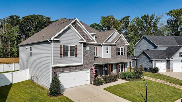 craftsman-style house with a garage and a front lawn