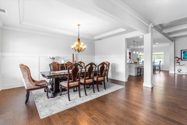 dining area featuring dark hardwood / wood-style floors, a chandelier, and crown molding