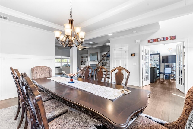 dining room with ornamental molding, hardwood / wood-style floors, beamed ceiling, and a chandelier