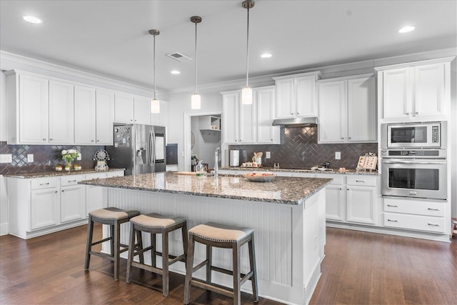 kitchen featuring dark hardwood / wood-style floors, appliances with stainless steel finishes, white cabinetry, and hanging light fixtures