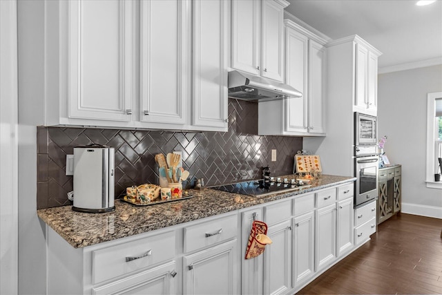 kitchen featuring white cabinets, appliances with stainless steel finishes, dark hardwood / wood-style flooring, and crown molding