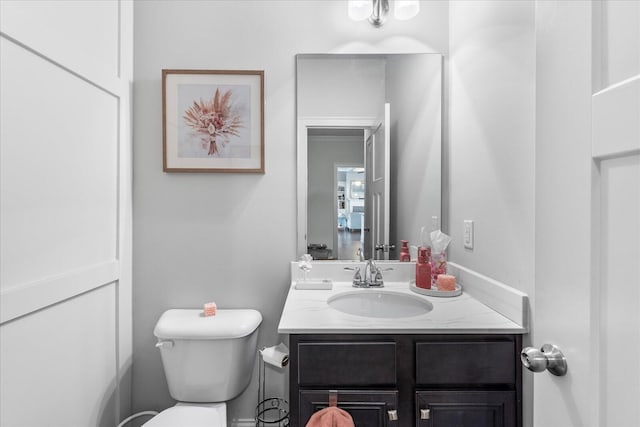 bathroom featuring toilet and vanity