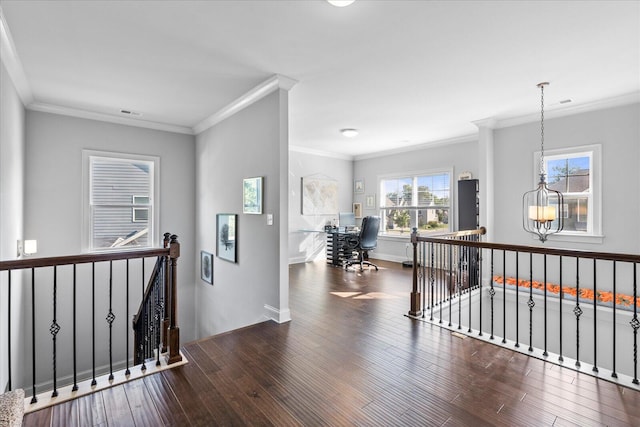 corridor featuring ornamental molding, dark hardwood / wood-style flooring, and a notable chandelier