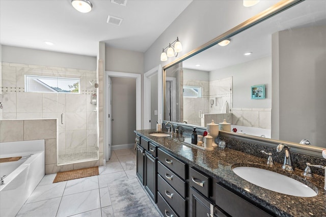 bathroom featuring vanity and separate shower and tub