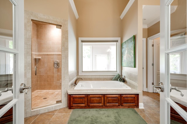 bathroom featuring shower with separate bathtub, crown molding, and tile patterned floors