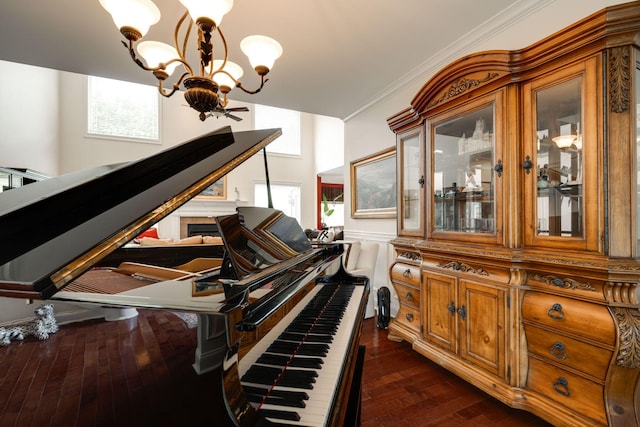 interior space with wood-type flooring, crown molding, and a notable chandelier