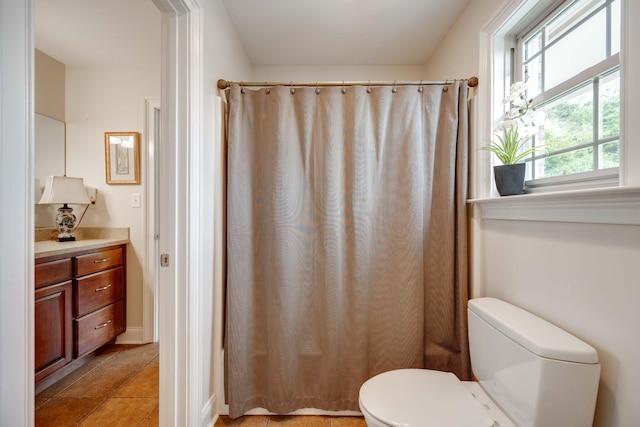 bathroom featuring tile patterned flooring, vanity, and toilet