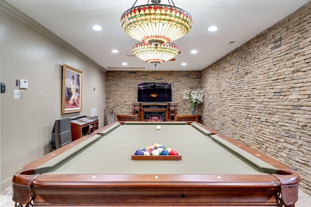 rec room with a fireplace, crown molding, and pool table