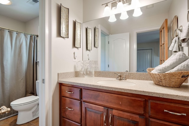 bathroom featuring vanity, toilet, and tile patterned floors