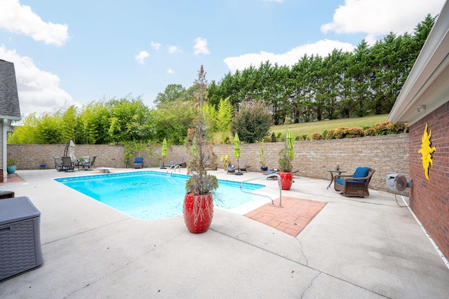 view of pool featuring a diving board and a patio